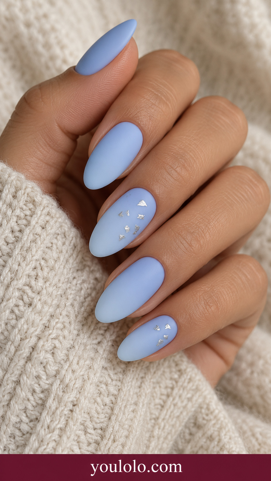 medium almond icy blue nails two accents sparse tiny flat irregular silver foil fragments, smooth finish on a naturally relaxed adult hand