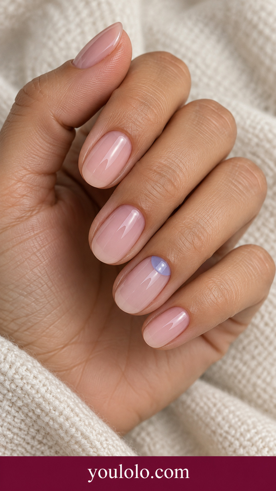 Transparent Blue Half Moon: short oval nude pink nails small translucent blue low relief half moon near base of ring nail on a naturally posed adult hand