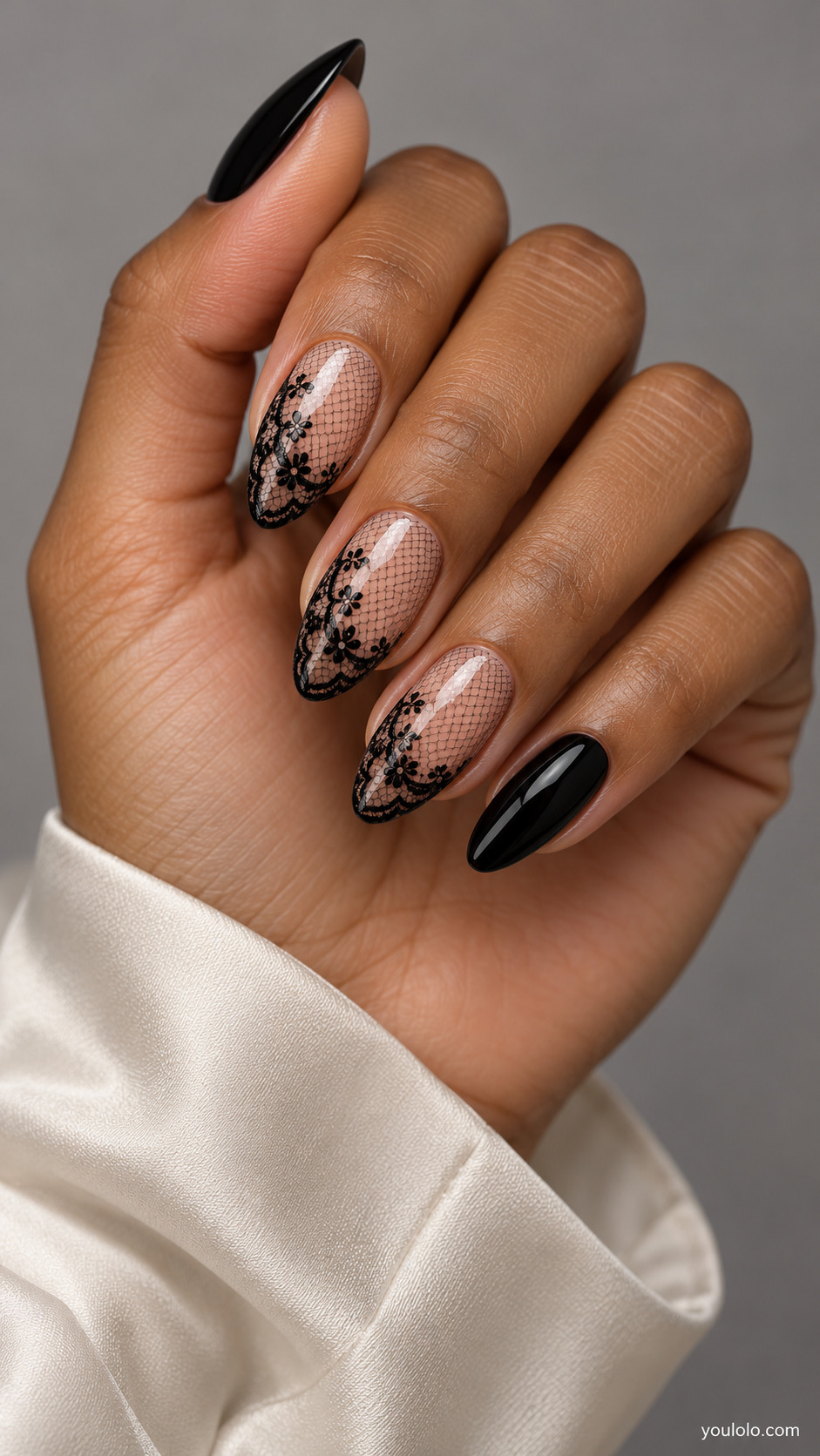 Black lace mesh and floral borders on sheer nude almond nails