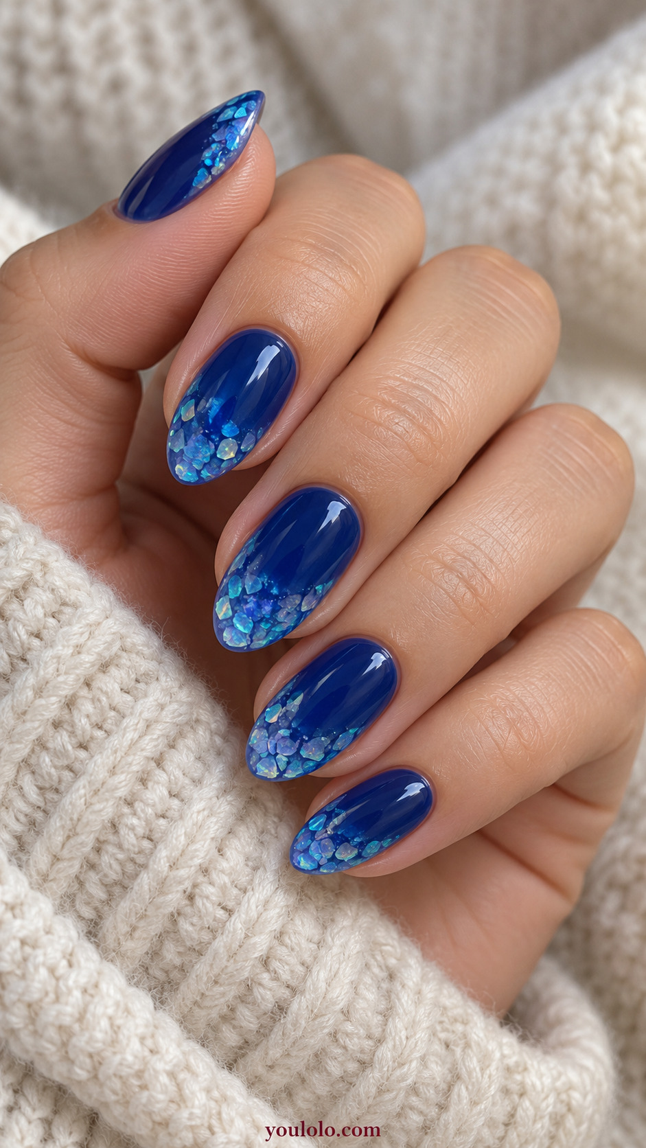 Blue Opal Flake Crescent Tips on a softly gathered feminine hand with detailed sapphire blue manicure