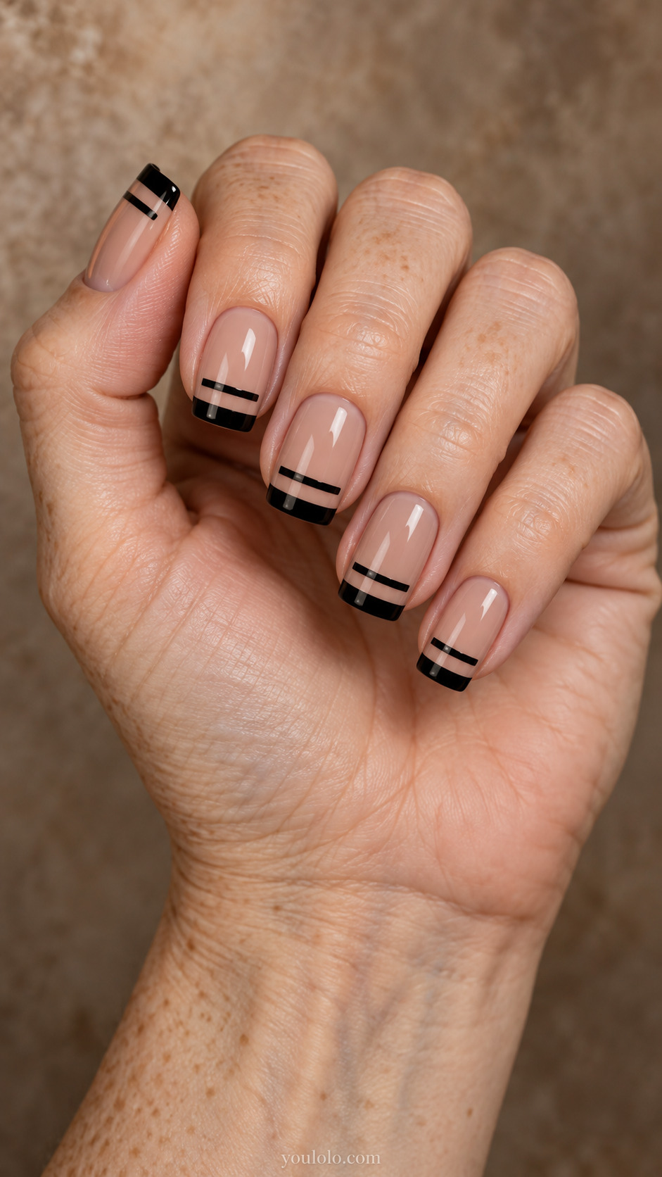 Square nude nails with two black horizontal bands separated by clear space