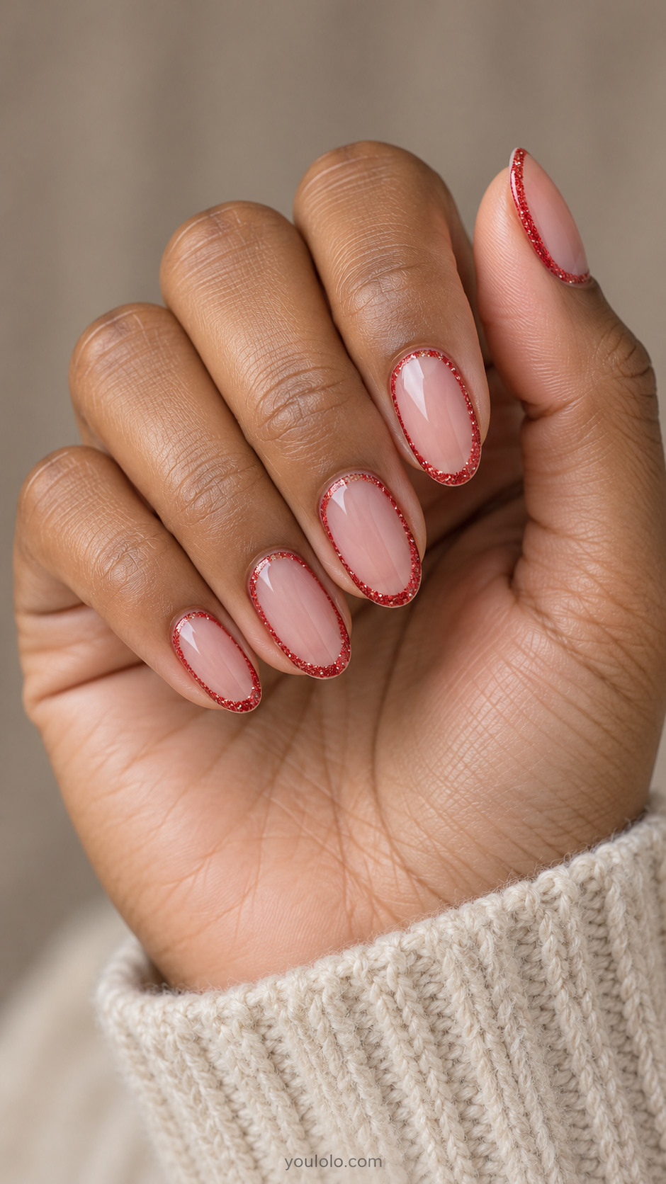 Sheer pink oval nails outlined with narrow red glitter frames
