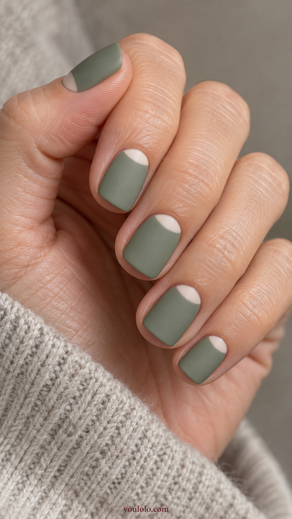 Sage Reverse French with Ivory Moons on a softly gathered feminine hand with a matte green manicure