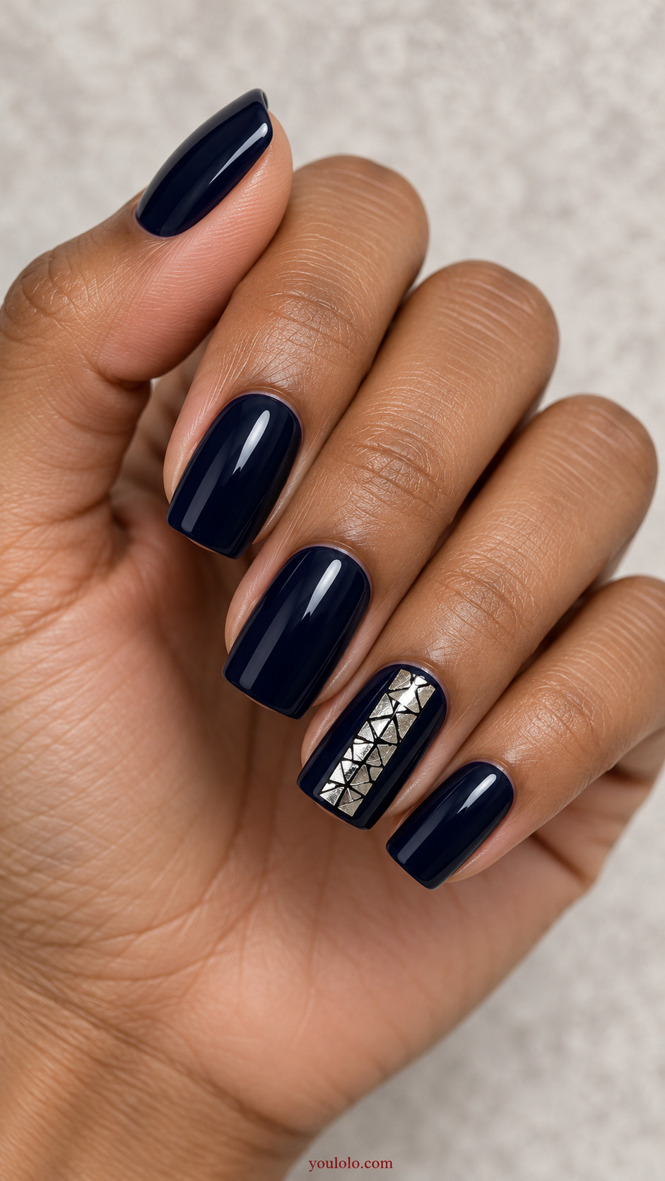 Silver Foil Mosaic Window on a naturally posed hand, showing dark blue polish and detailed nail art