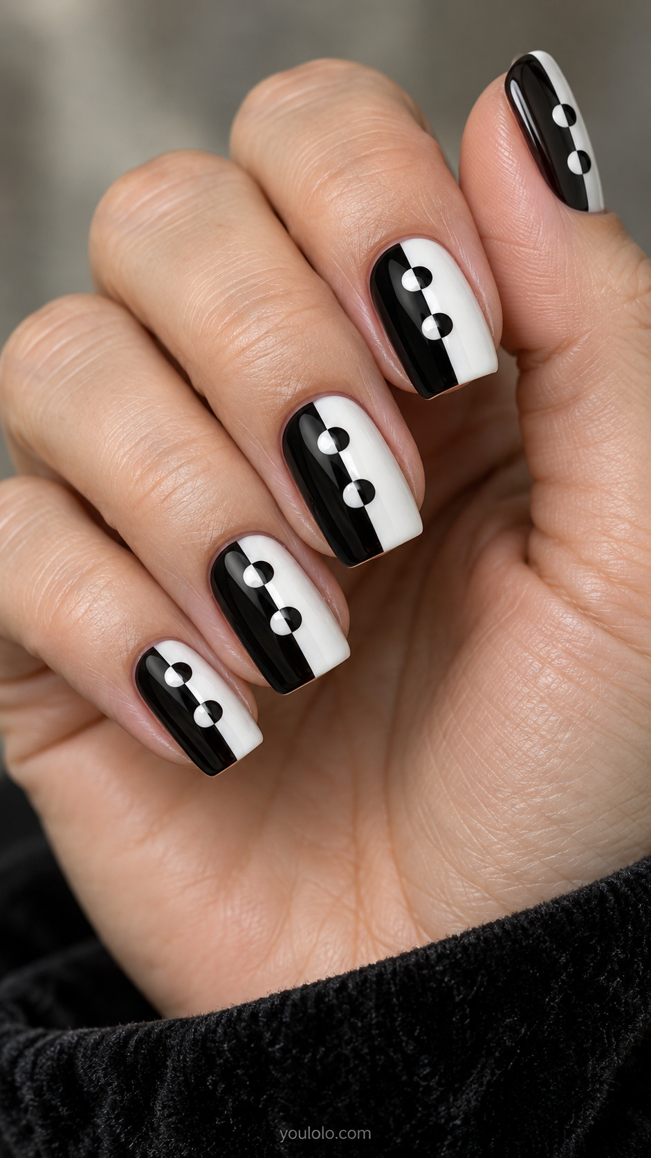 Medium square nails split vertically black and white, dots straddle seam as perfect circles half white on black side half black on white side