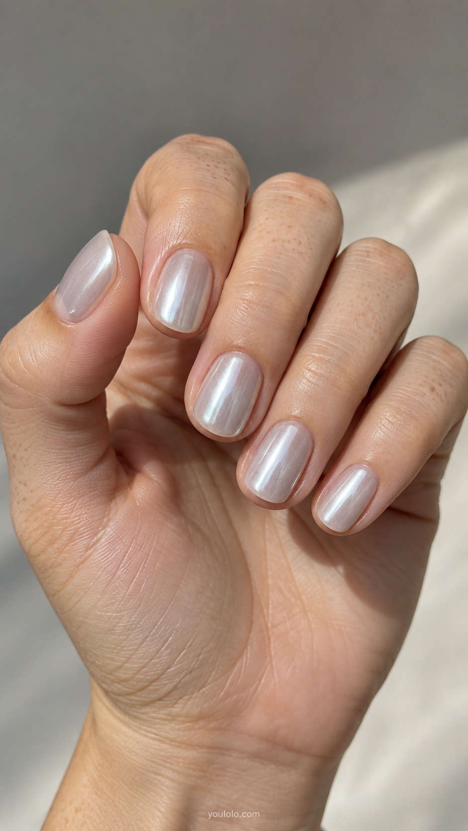 Oyster Pearl fall chrome nails — milky translucent gray ivory base with cool silver pearl chrome sheen, delicate not opaque mirror, short round nails