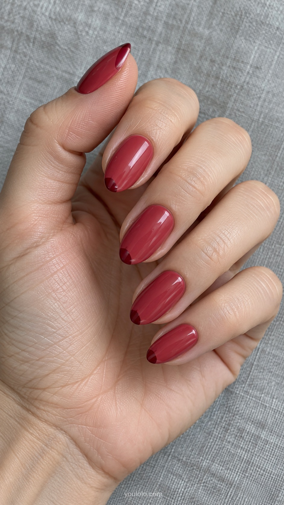 Medium almond nails muted watermelon red cream with darker garnet tiny corner accents