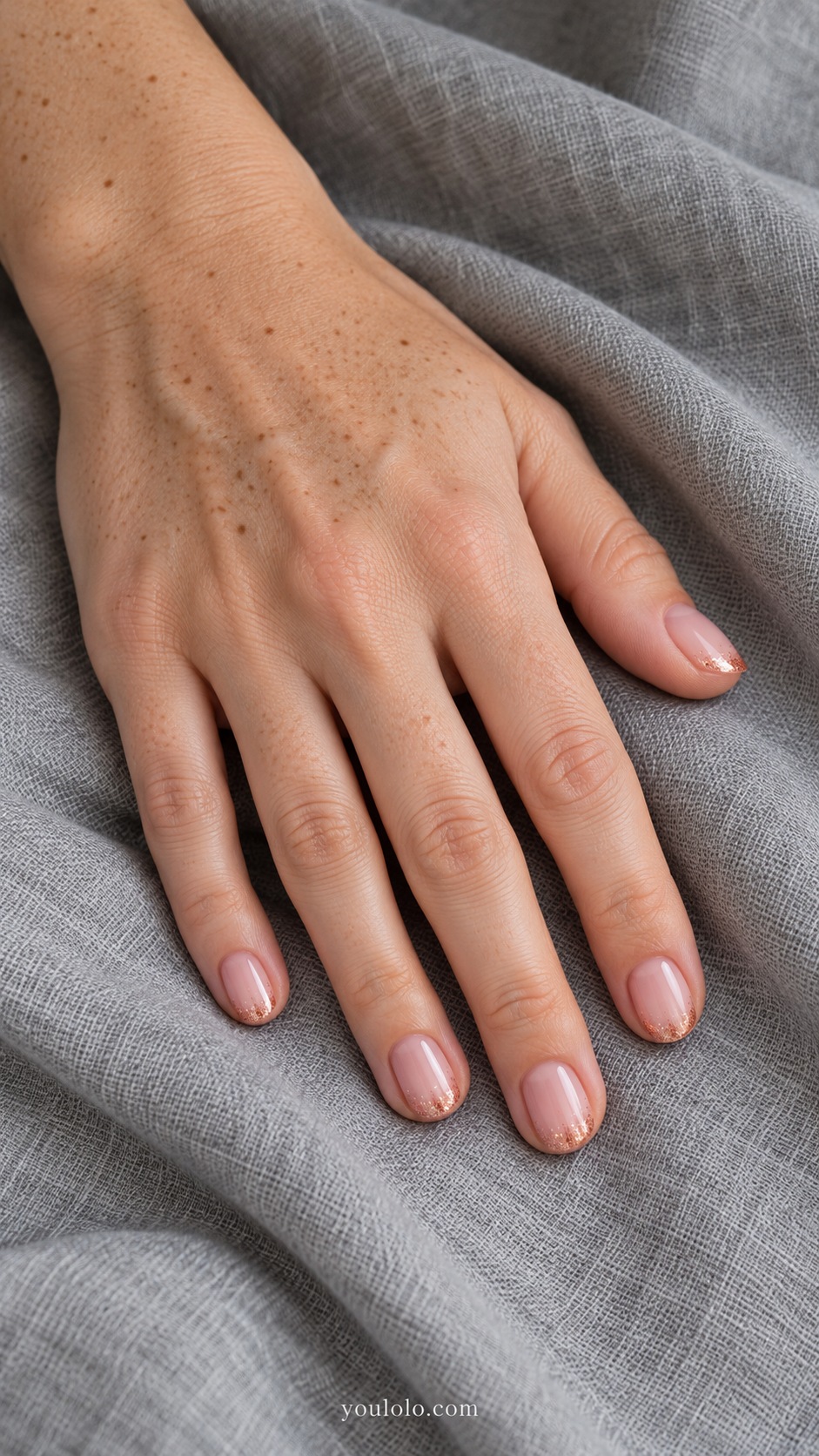 Short round nails sheer warm pink sparse fine copper shimmer just at tips