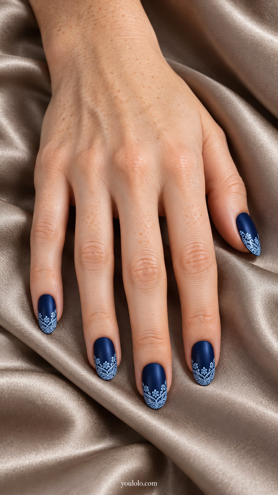 Midnight Lace Tips: medium oval deep navy nails, pale blue delicate lace trim across tips, satin background finish