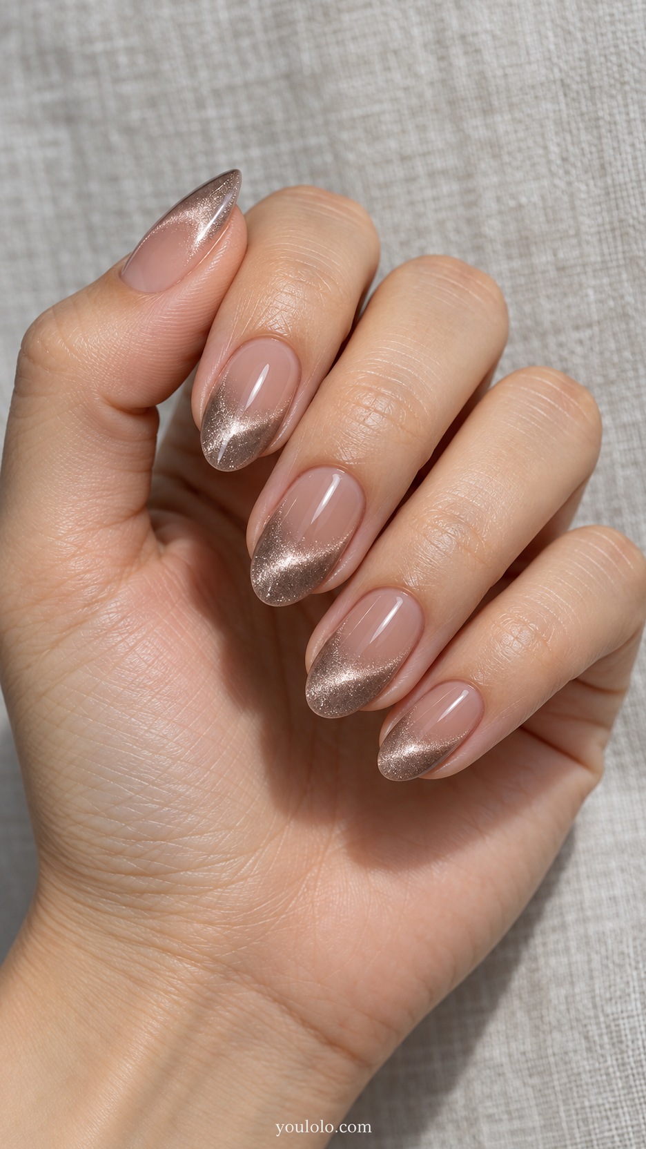 French Cat Eye Nails: medium oval nude beds taupe magnetic curved stripe near tip separated from free edge by narrow nude margin
