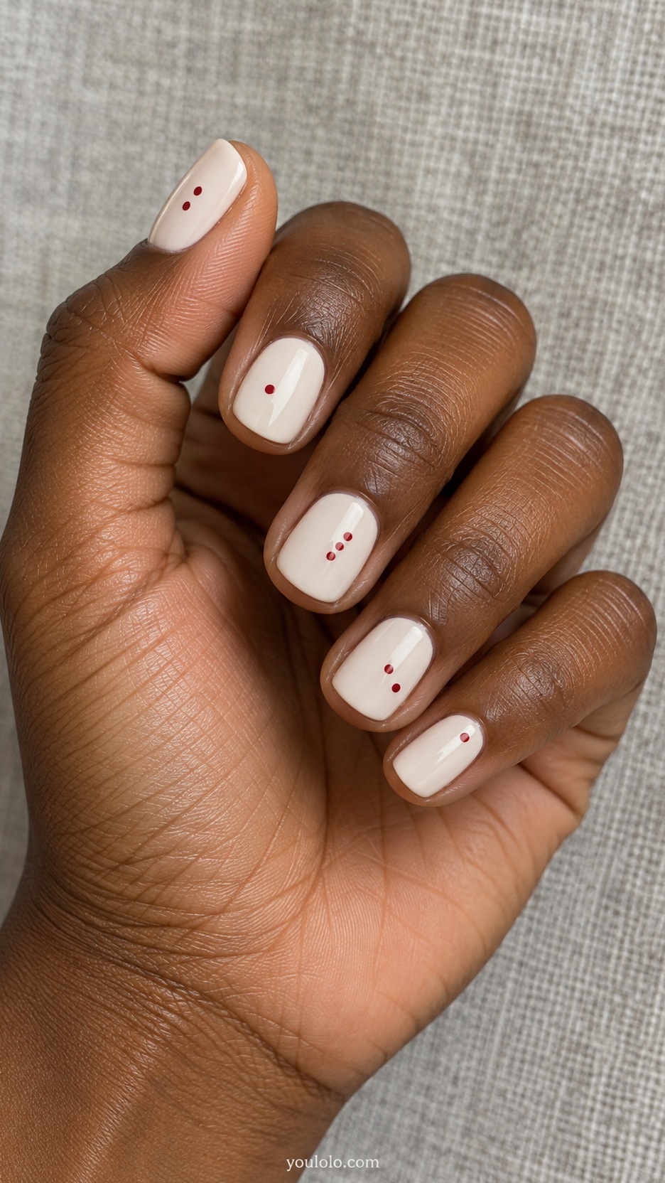 Short Artsy Nails: Red Dot Composition manicure on a naturally posed hand