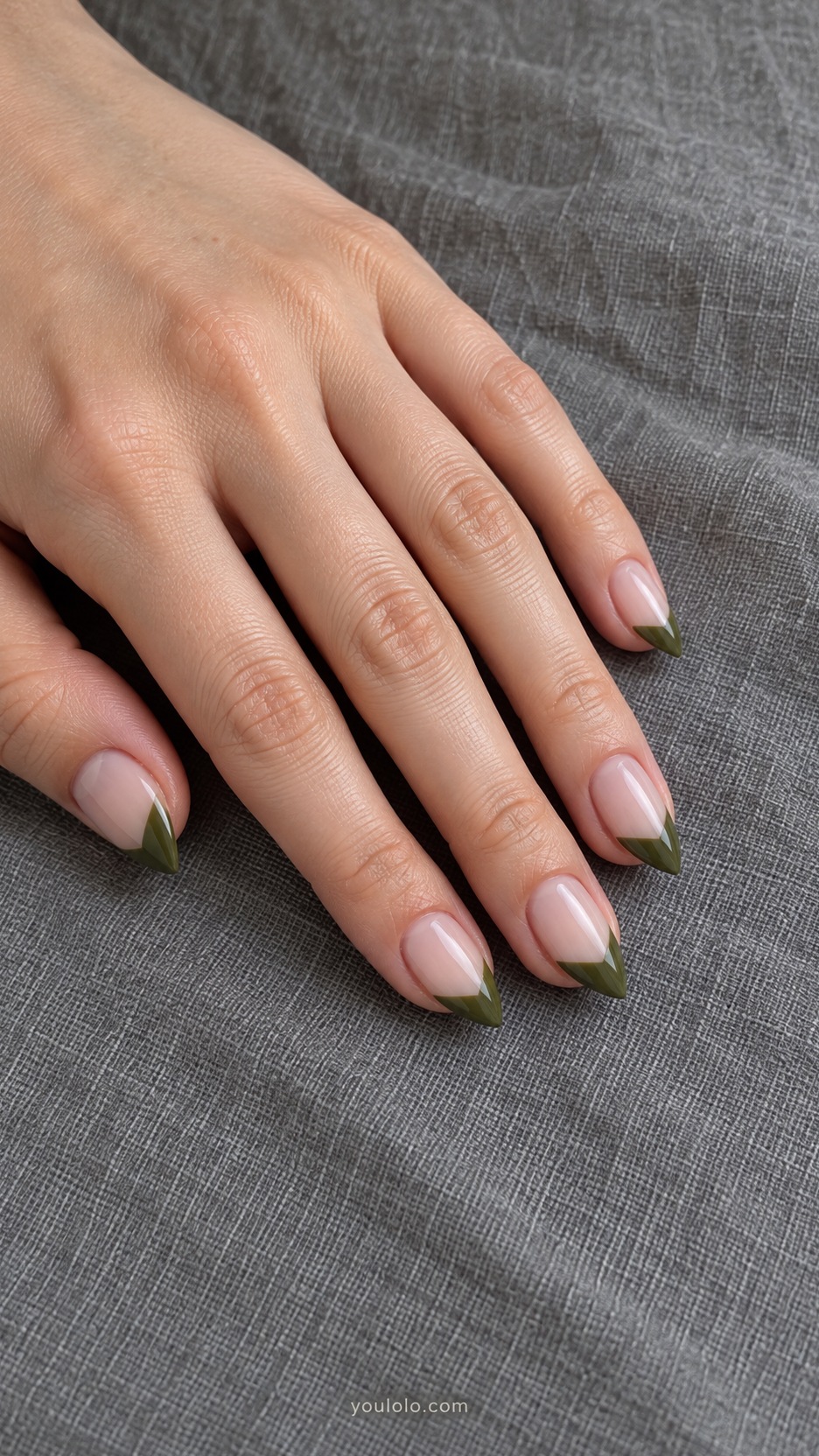 Short Stiletto French Nails: Olive Diagonal French manicure on a naturally posed hand