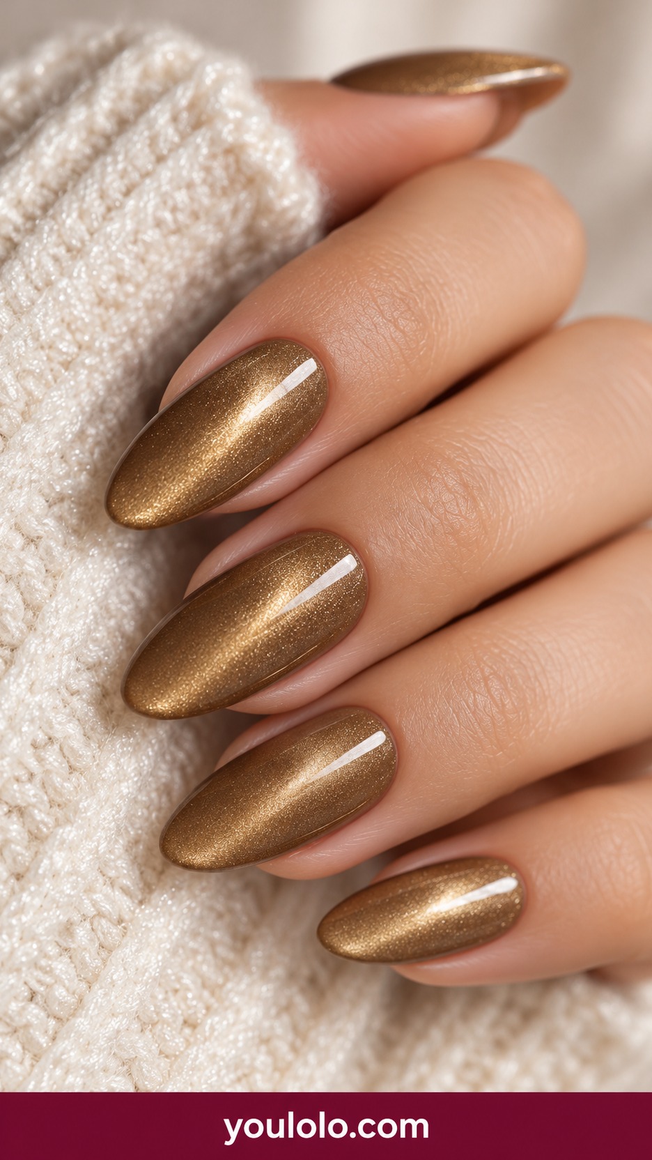 Medium oval muted antique gold magnetic nails soft diffuse velvet light no art on a naturally curled young adult hand