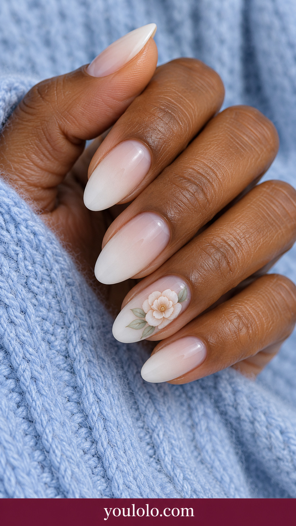medium oval translucent milky white nails one delicate flat painted white camellia outlined warm beige with pale sage leaves on ring nail on a naturally relaxed adult hand