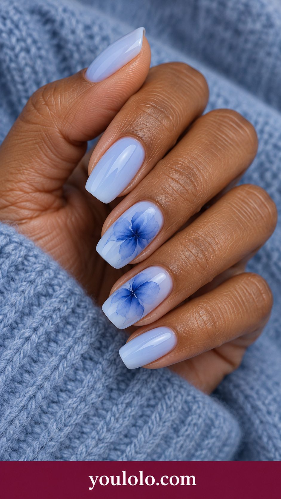Indigo Botanical Haze: medium soft square translucent pale blue nails two accents indigo blooming loose flower silhouettes with diffused edges on a naturally posed adult hand