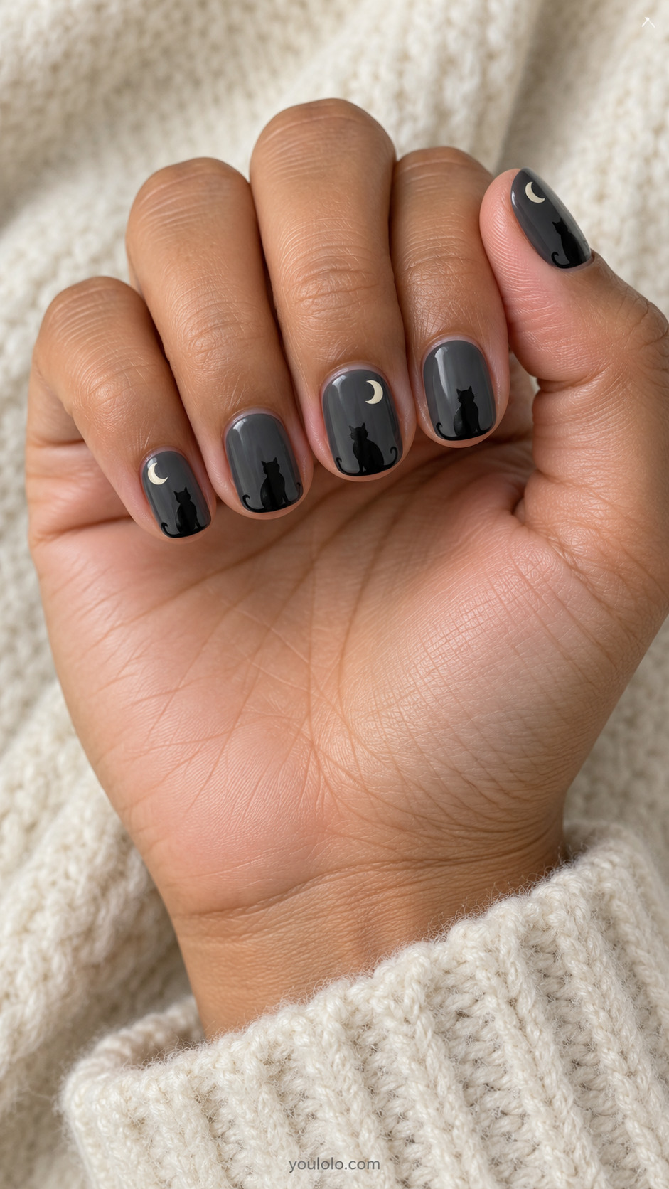 Short squoval charcoal gray nails with solid black sitting cat silhouette near tip, narrow ivory crescent uppercorner on alternating nails