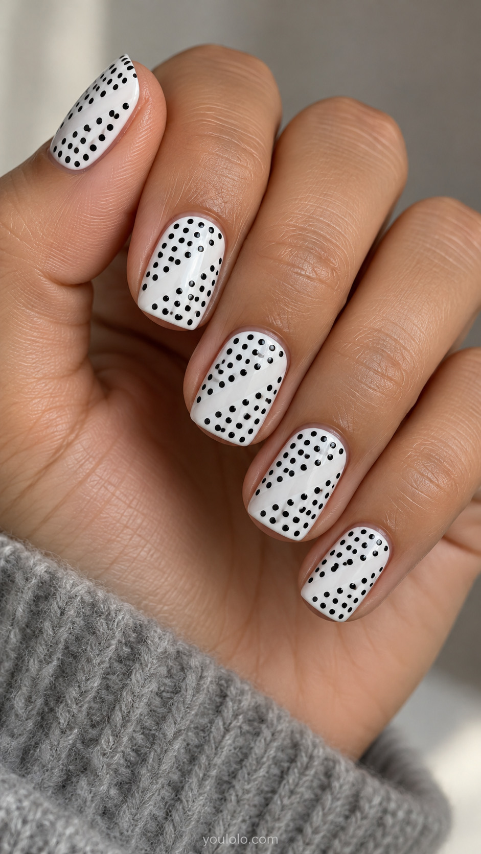 Short square white nails with neat grid of small black dots, a deliberate empty diagonal row missing through middle creating blank diagonal channel