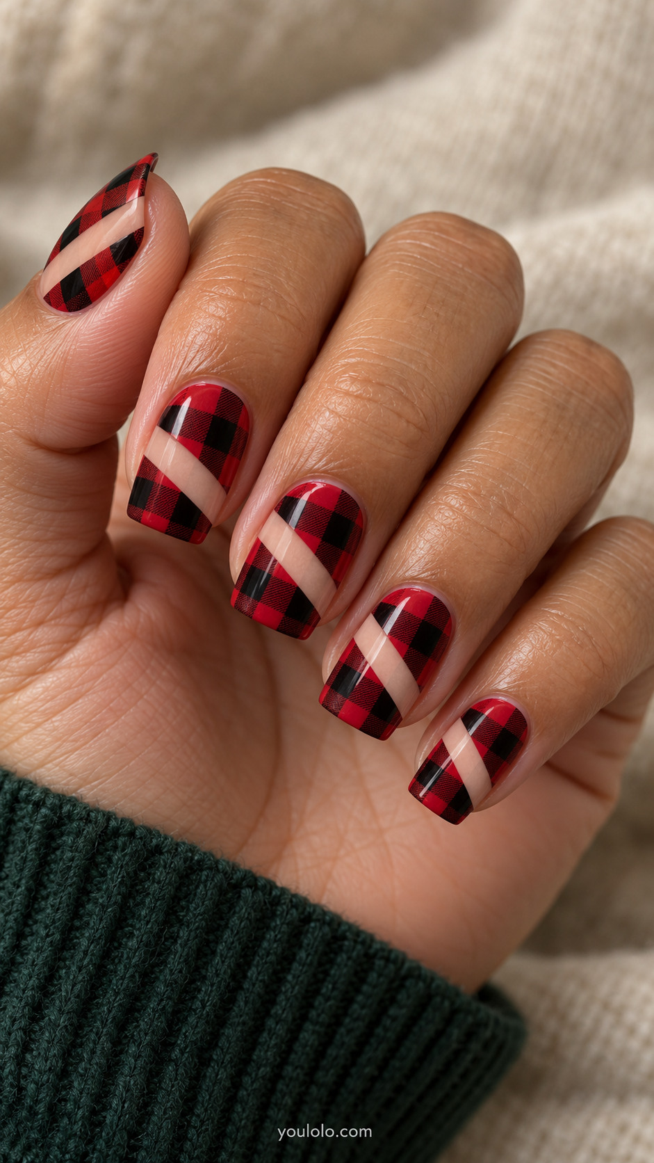 Square red-and-black buffalo check nails interrupted by diagonal nude stripes