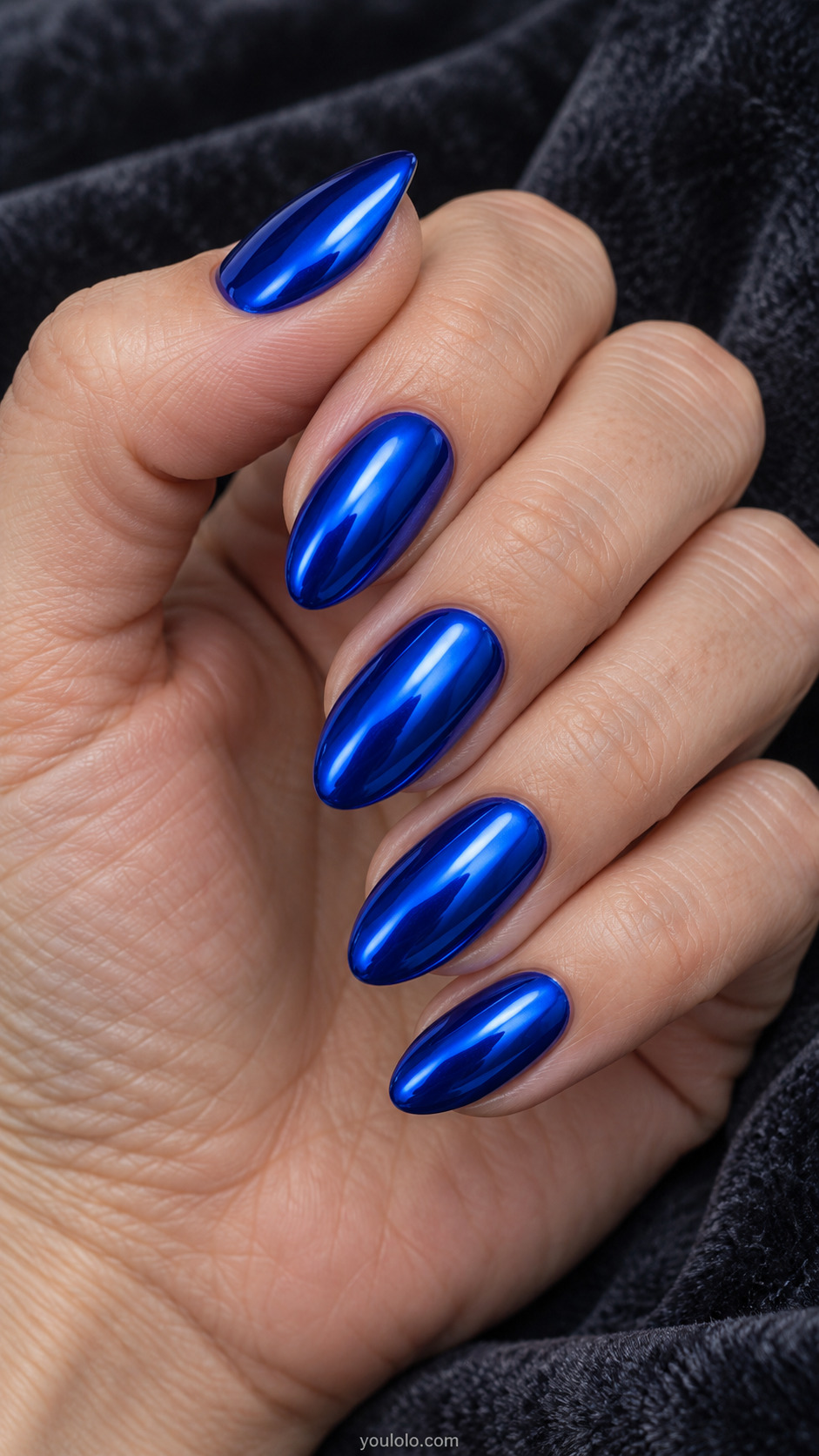 Almond nails with a reflective metallic royal blue chrome finish