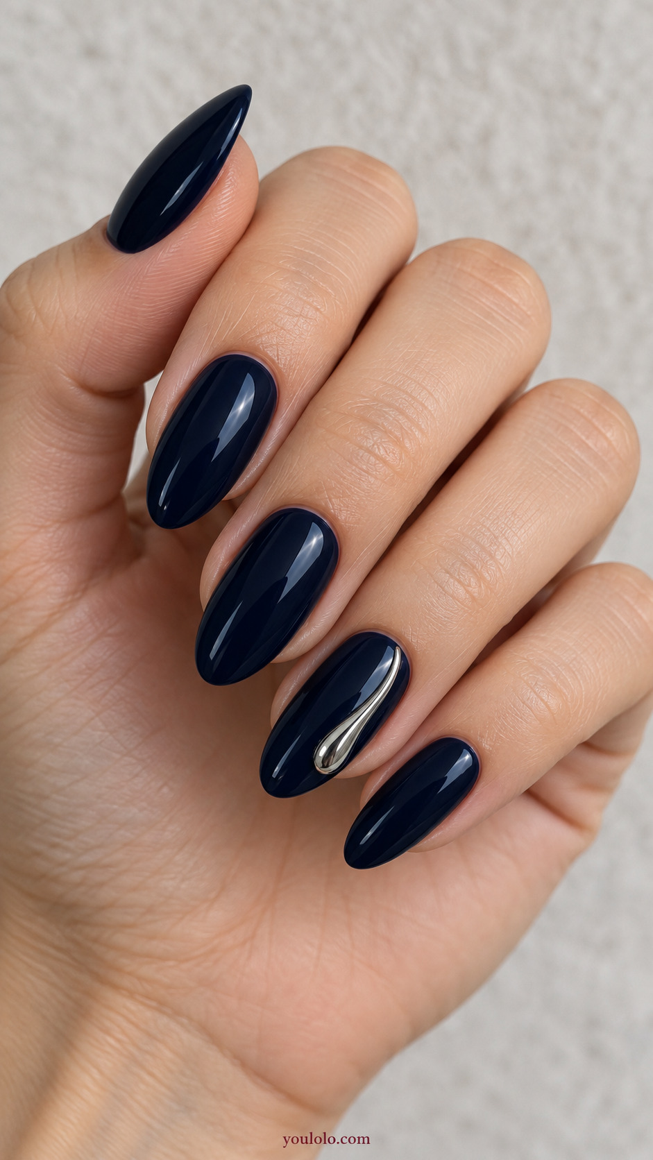 Liquid Silver Side Droplet on a naturally posed hand, showing dark blue polish and detailed nail art