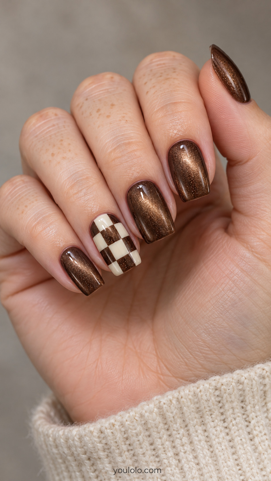 Medium square nails: brown magnetic velvet nails; ring accent has large flat cream checker squares leaving alternating brown magnetic squares visible, others plain.