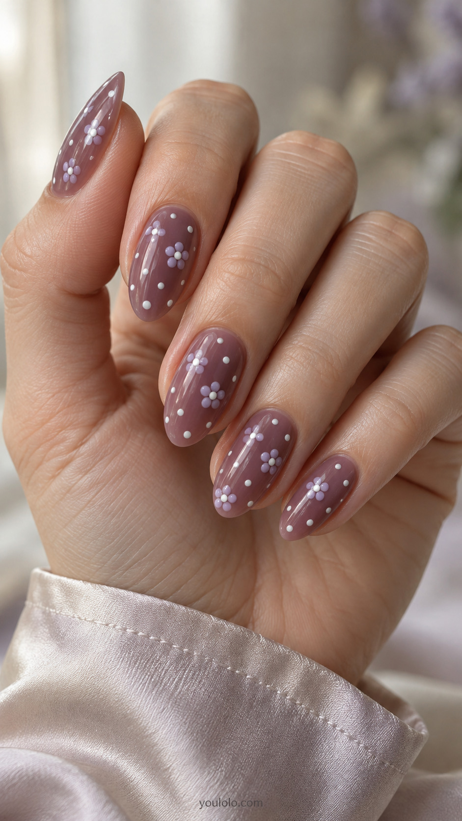 Grape jelly almond nails with tiny ivory dots and lavender daisies.
