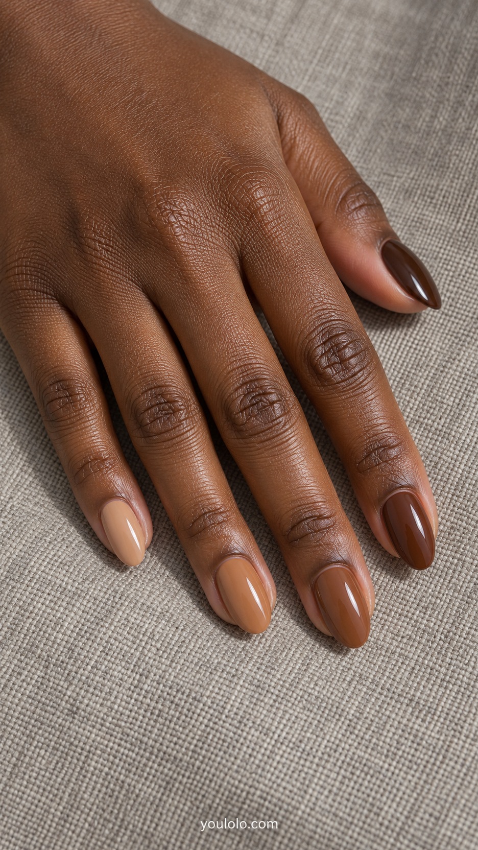 Short Almond Nail Designs: Toffee Tonal Set manicure on a naturally posed hand