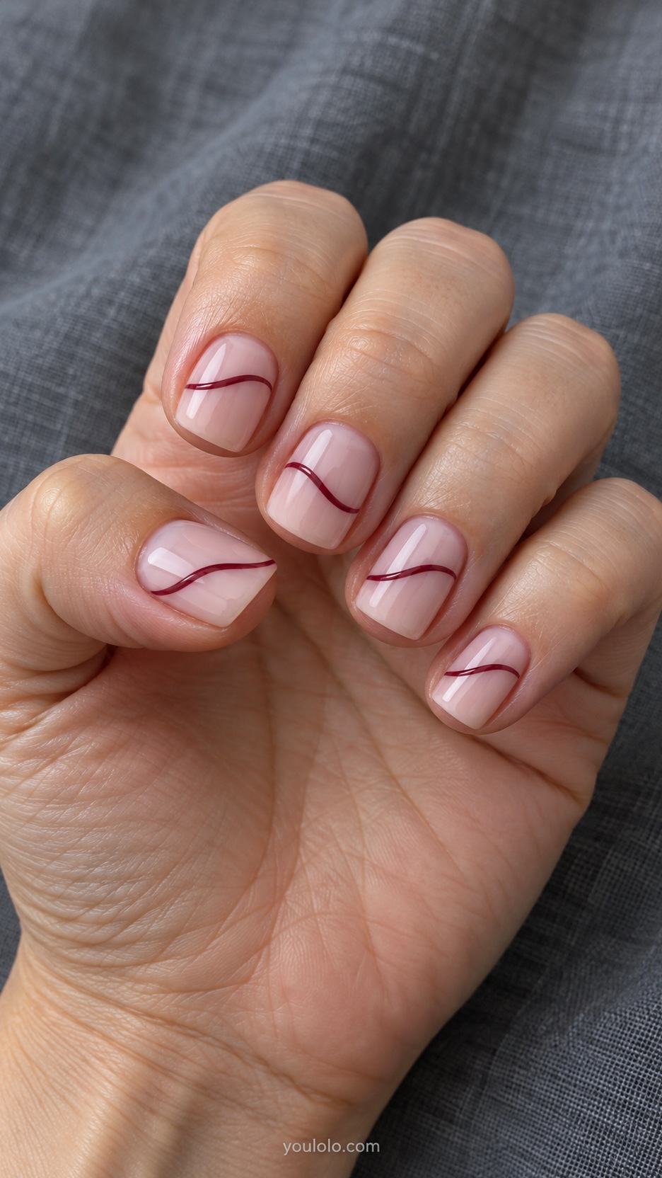 Short Square Nail Designs: Burgundy Ribbon Line manicure on a naturally posed hand