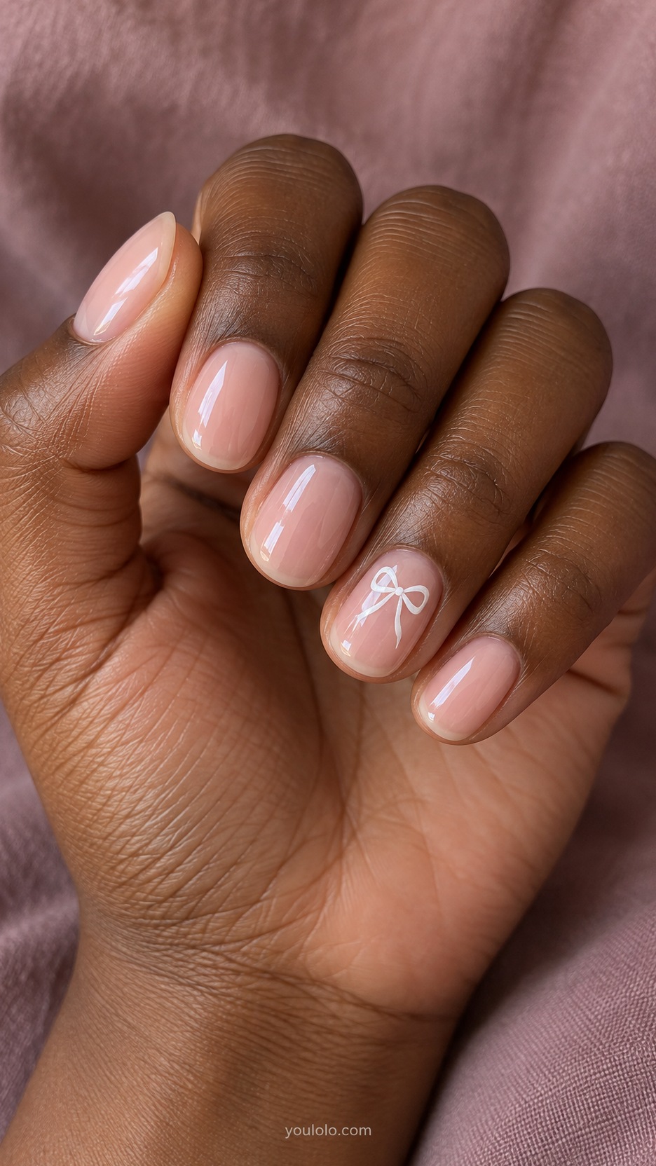 Short Wedding Nails: Tiny White Bow manicure on a naturally posed hand