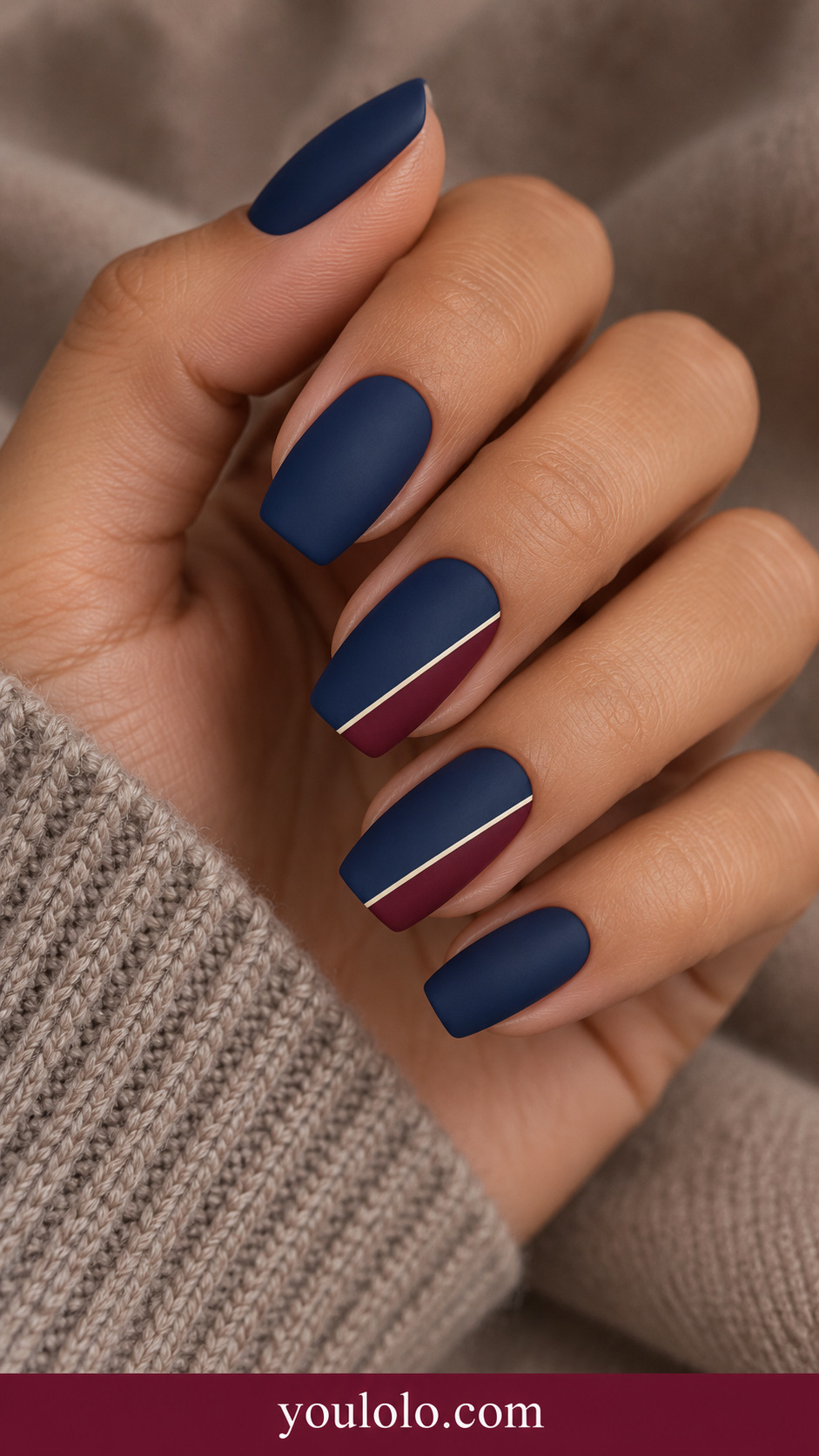 medium soft square navy nails two accents diagonal burgundy corner panels separated by extremely thin ivory line on a naturally relaxed adult hand