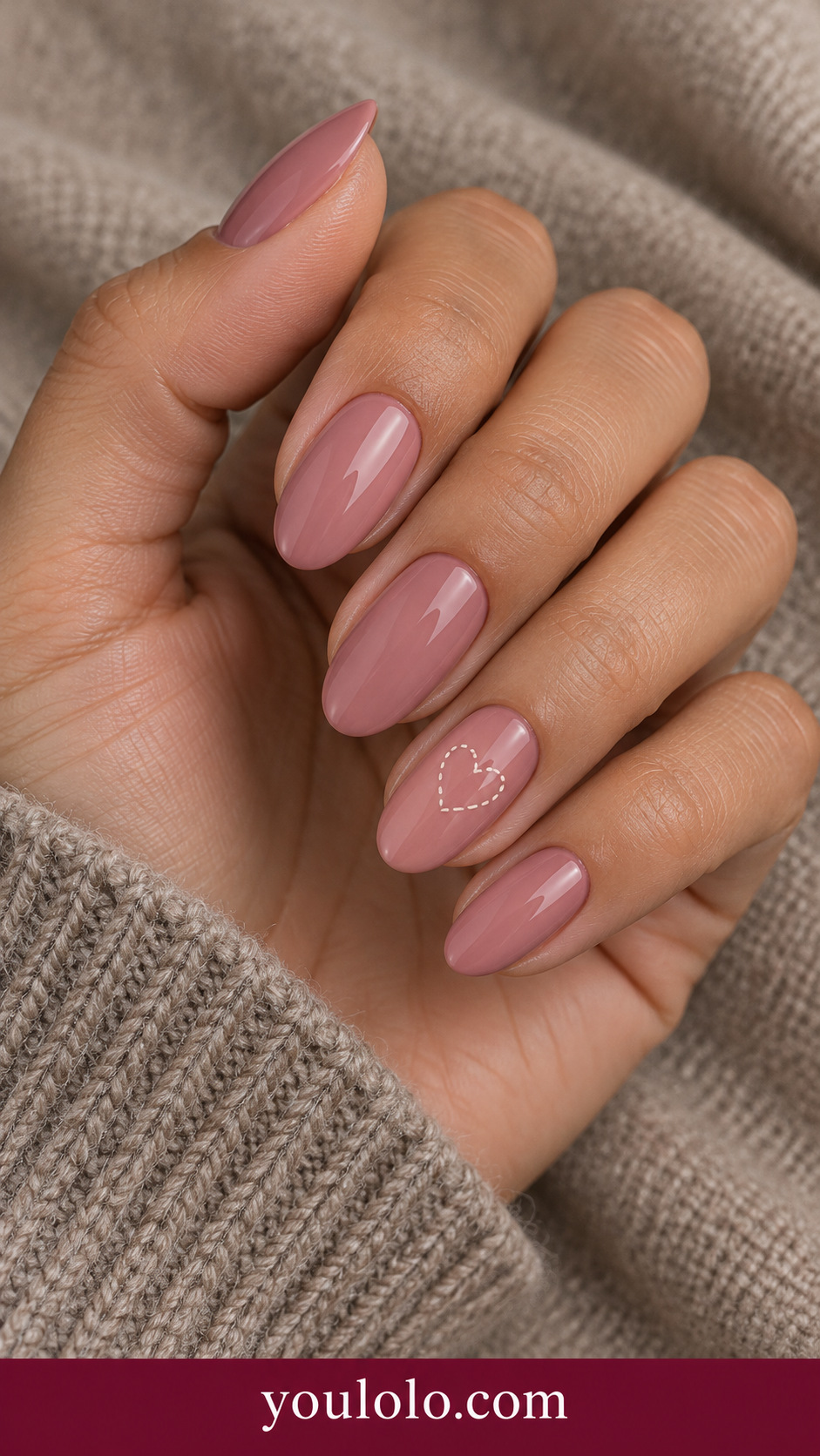 Ivory Stitched Heart: medium oval muted rose nails one small ivory heart outline made of tiny painted dashed stitch marks on ring nail on a naturally posed adult hand