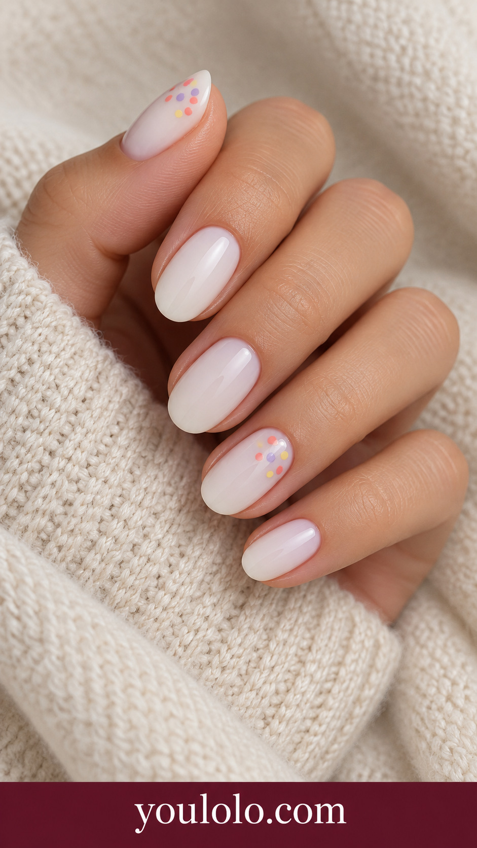 Summer Sorbet Dots: short oval milky cream nails two accents loose cluster tiny coral lavender and yellow dots in one upper corner on a naturally posed adult hand