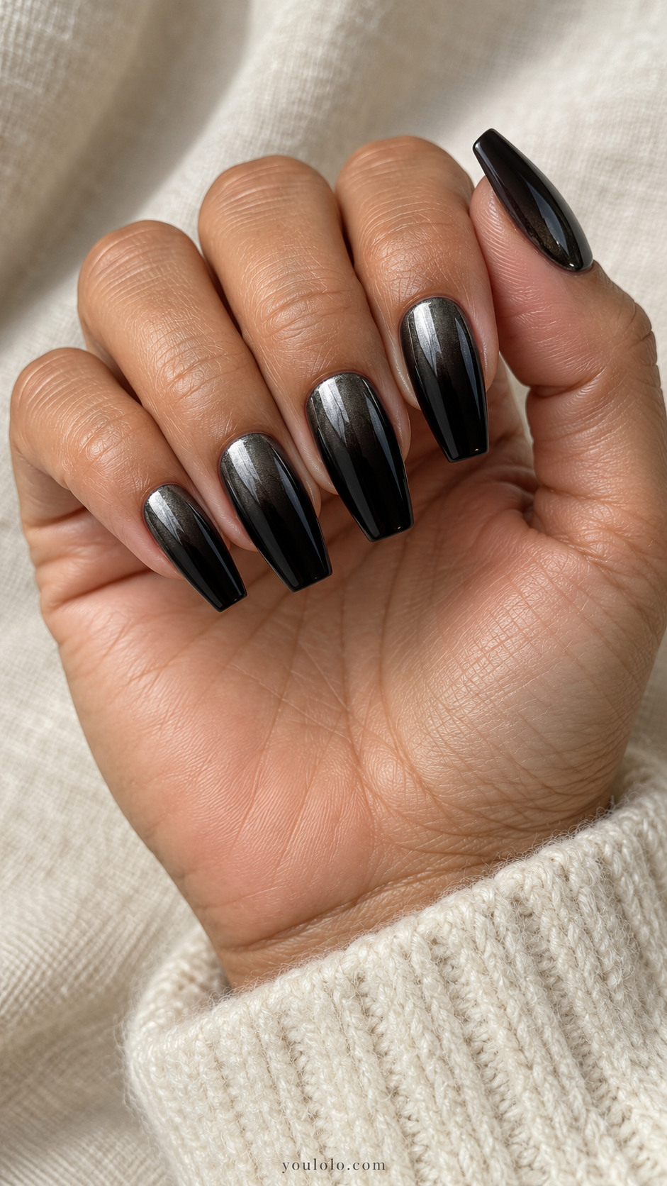 Medium coffin near-black opaque nails with gunmetal chrome sheen concentrated near cuticles fading down to plain black tips