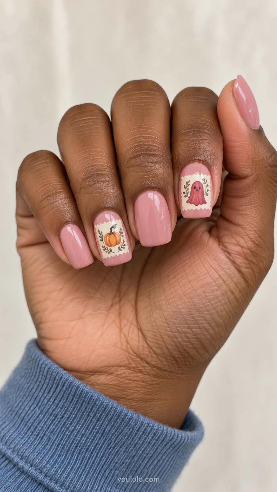 Dusty pink nails with cream stamp frames around ghost and pumpkin art