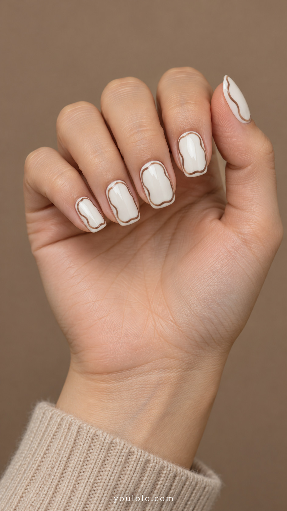 White squoval nails framed with thin wavy mocha outlines