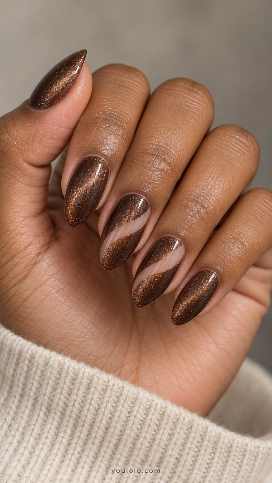 Medium almond nails: brown magnetic velvet nails with one narrow sheer nude curved diagonal channel crossing middle and ring, edges clean unoutlined, others full magnetic.