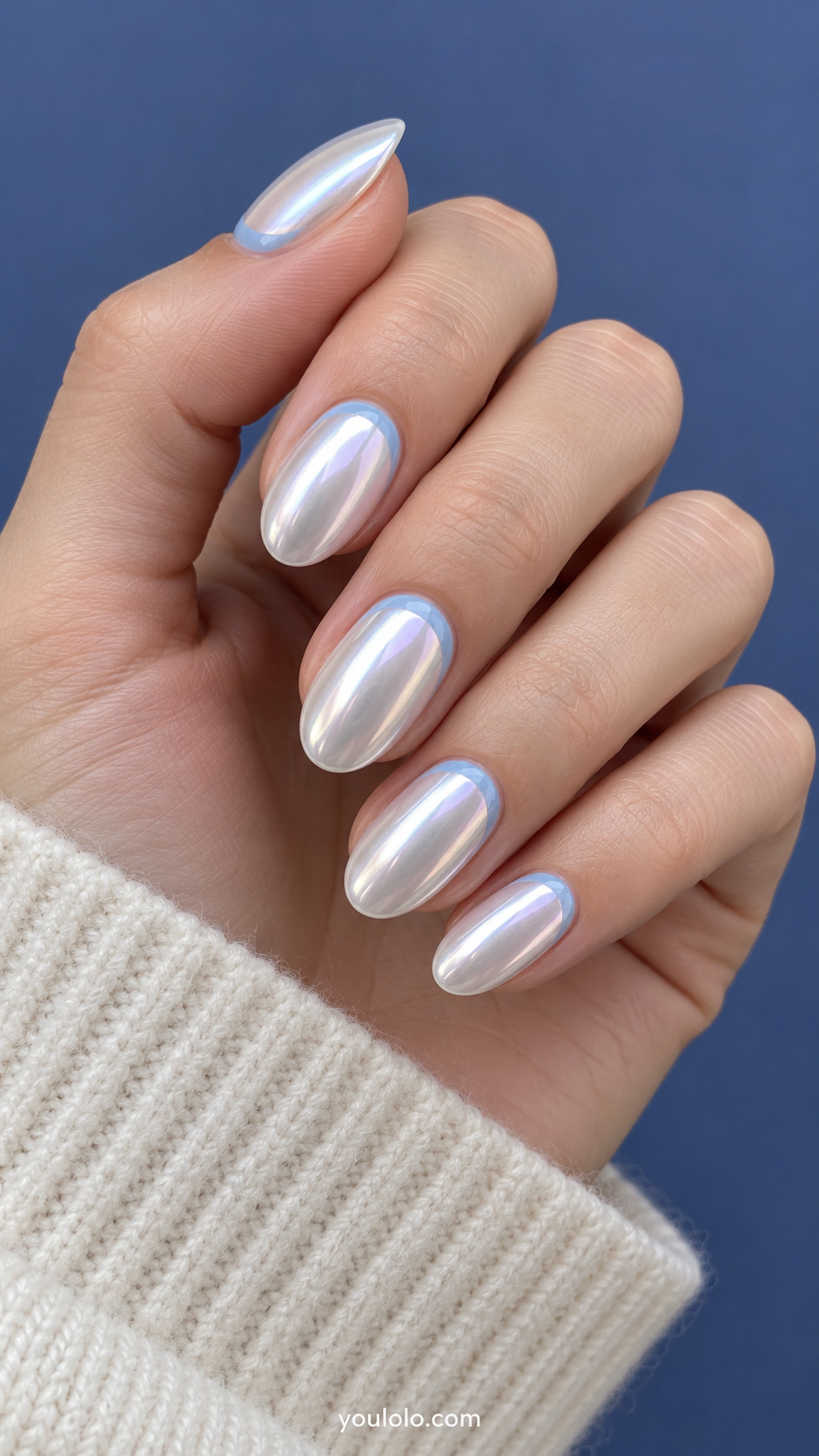 Pearl chrome oval nails with thin icy-blue reverse-French cuticle arcs.