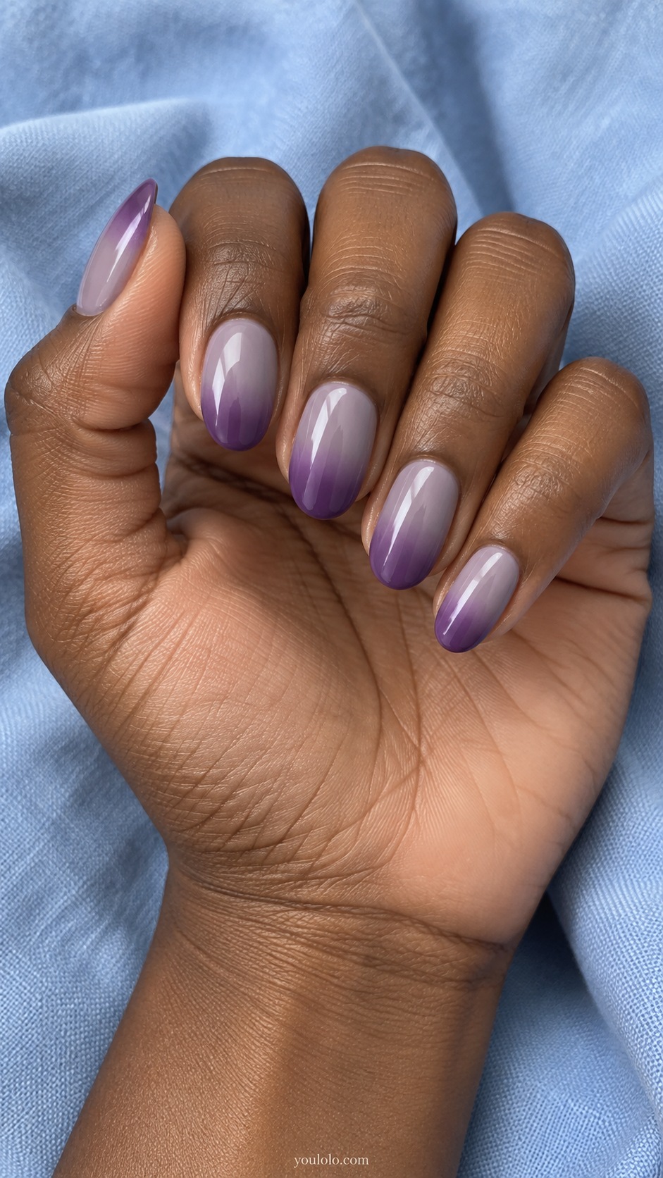 Medium oval nails smooth subtle gradient from dusty gray lavender at base to medium dried violet purple tips gloss