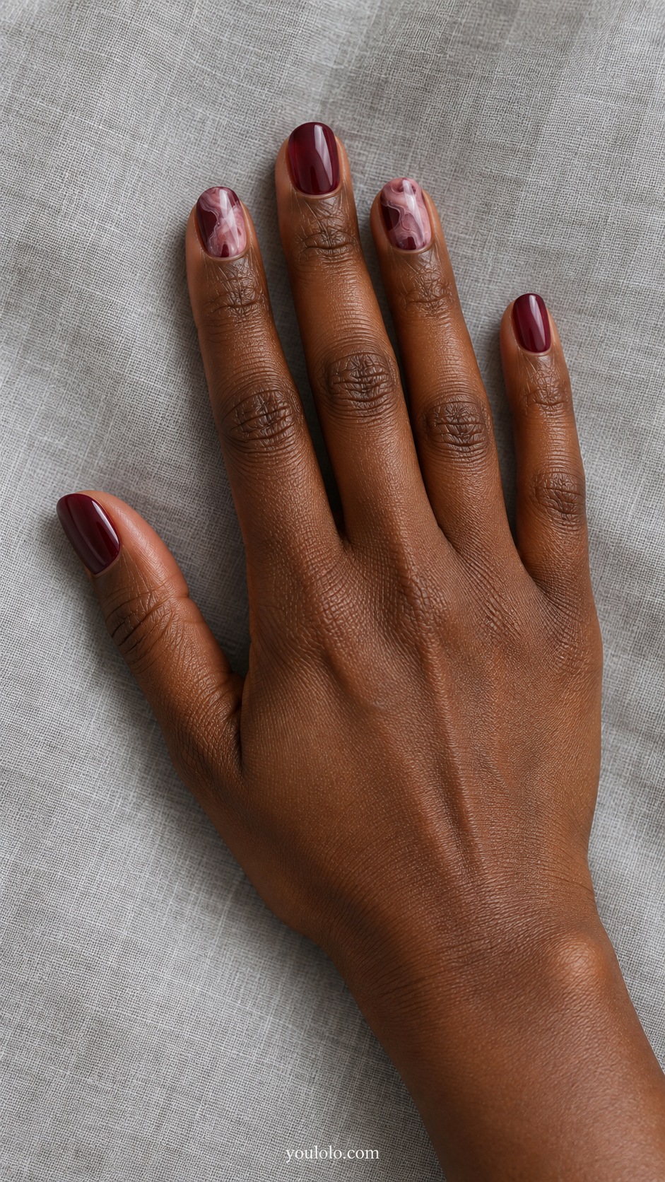 Short oval burgundy pearl nails two accent nails thin irregular dusty pink soft marble wisps
