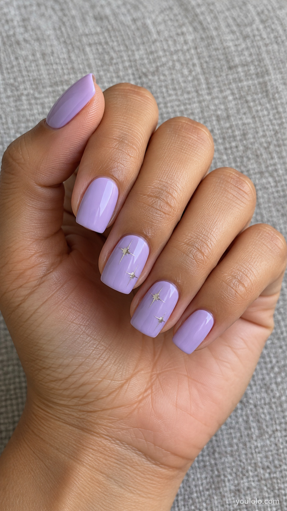 Lavender square nails with small silver sparkle stars on two nails