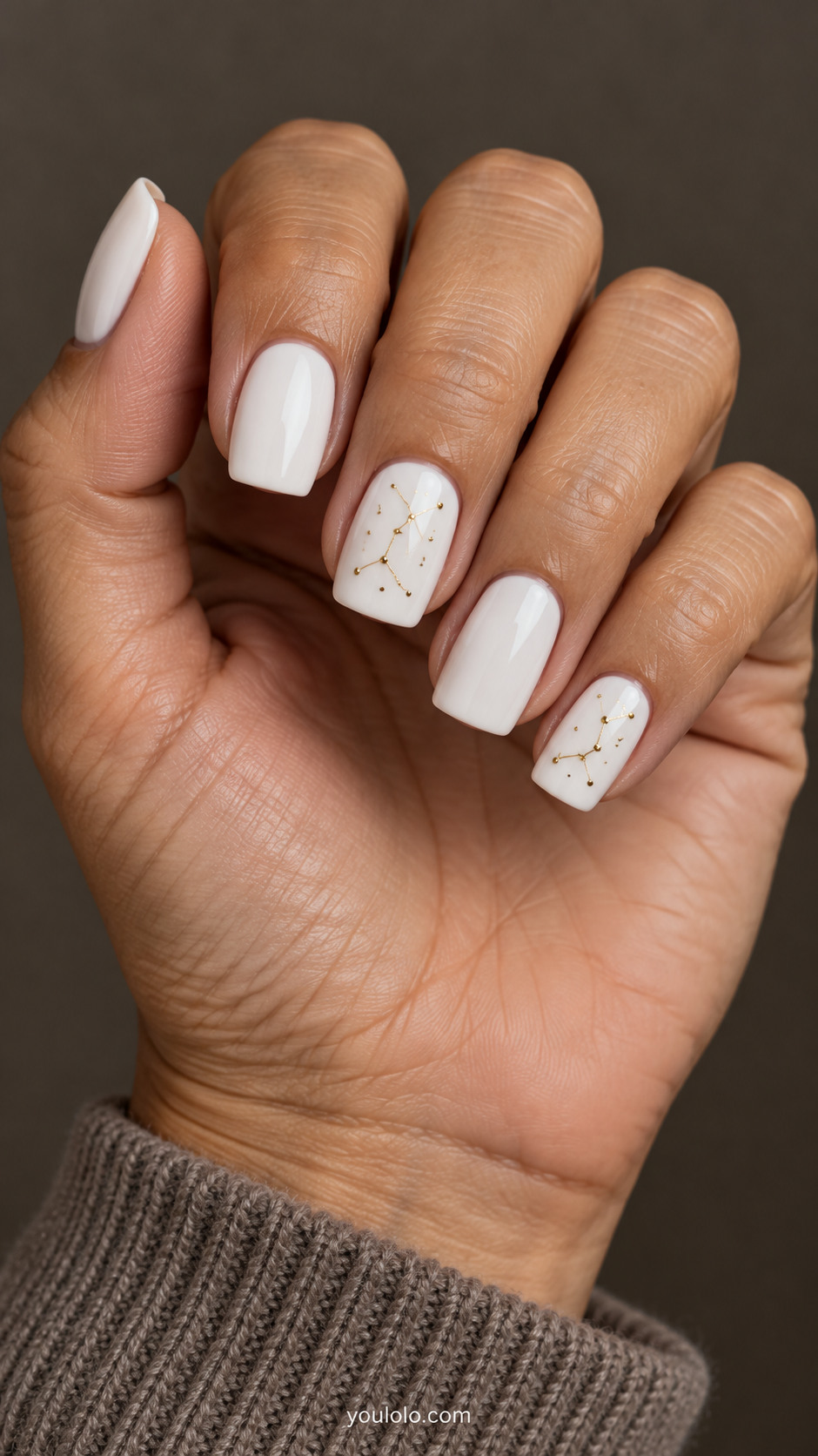 Medium square white nails with fine gold constellation lines and tiny dots on two accents