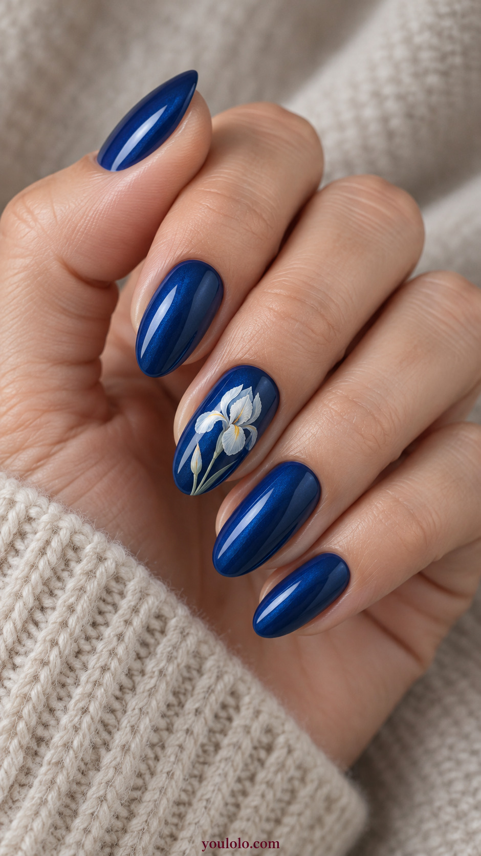 Sapphire with Miniature White Irises on a softly gathered feminine hand with detailed sapphire blue manicure