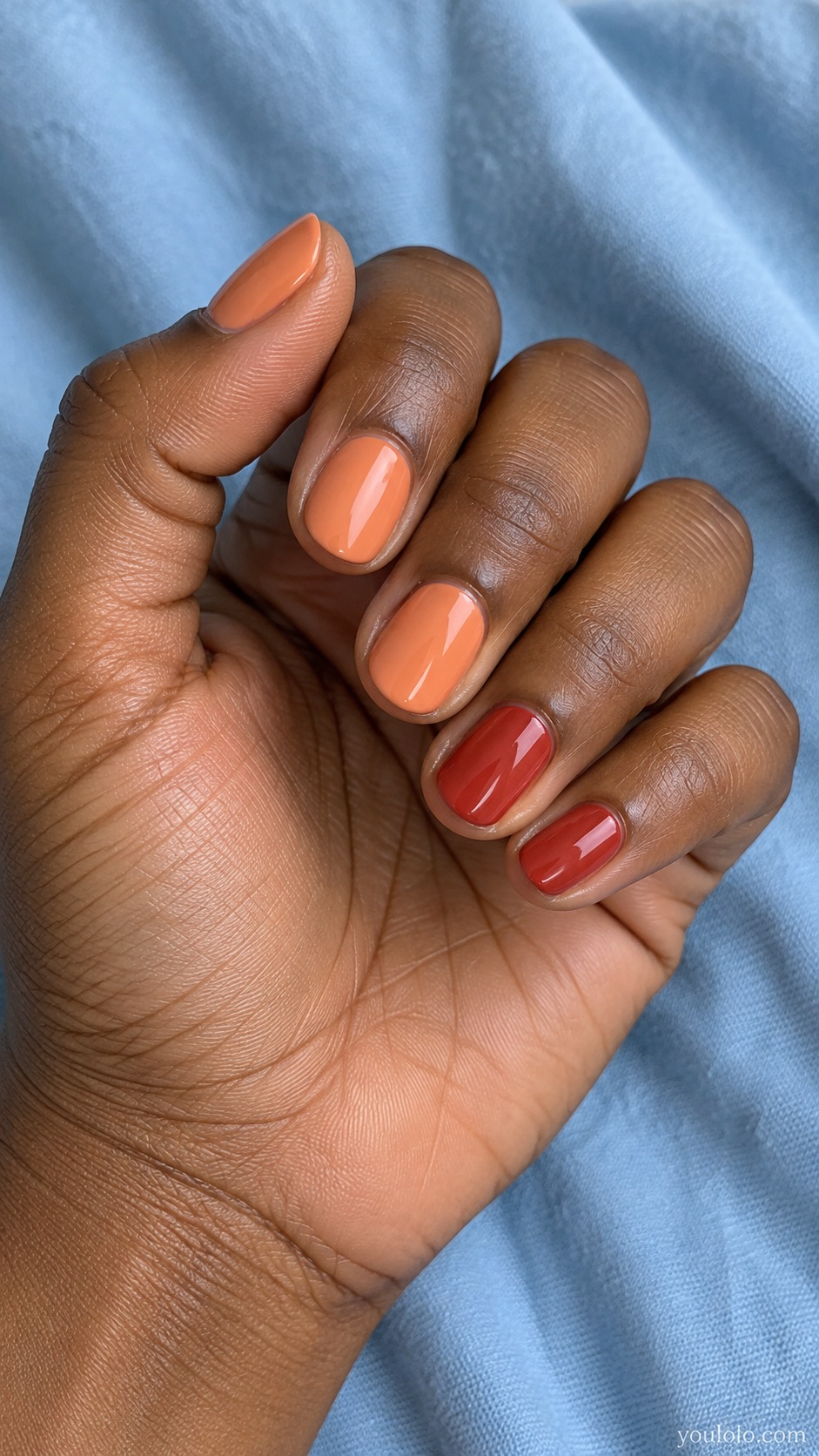 Short round nails warm muted peach orange cream thumb index middle, ring pinky warm spiced red cream