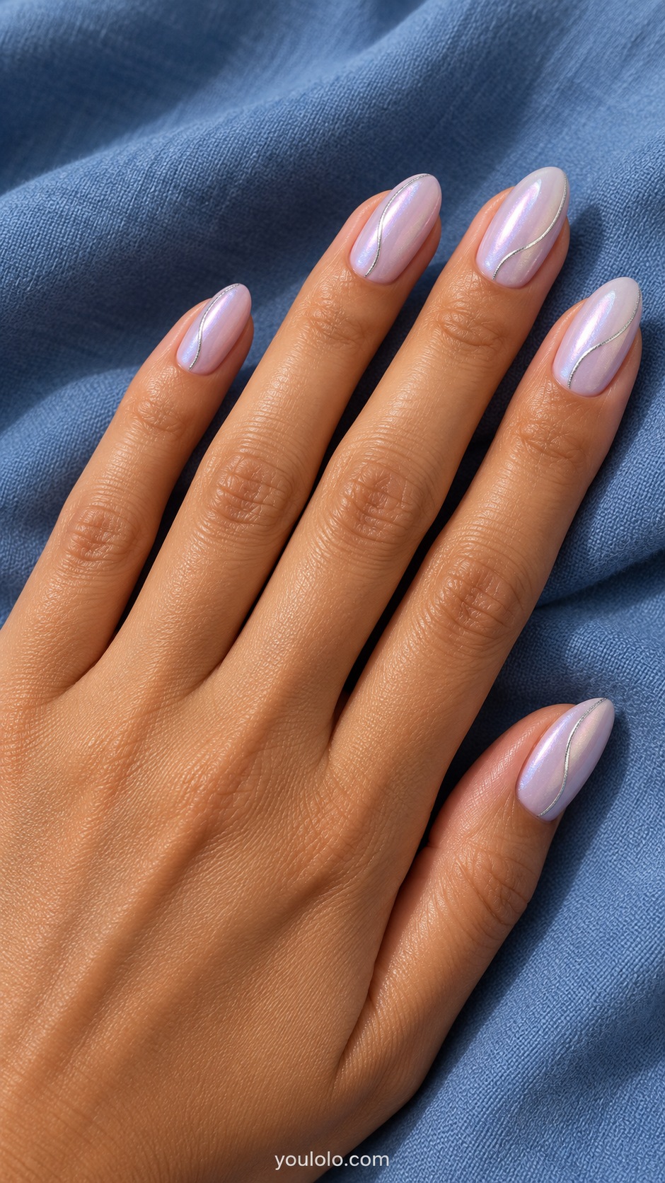 Medium almond nails pale lilac pearl glazed base, single fine silver curved line following one side of each nail, no beads