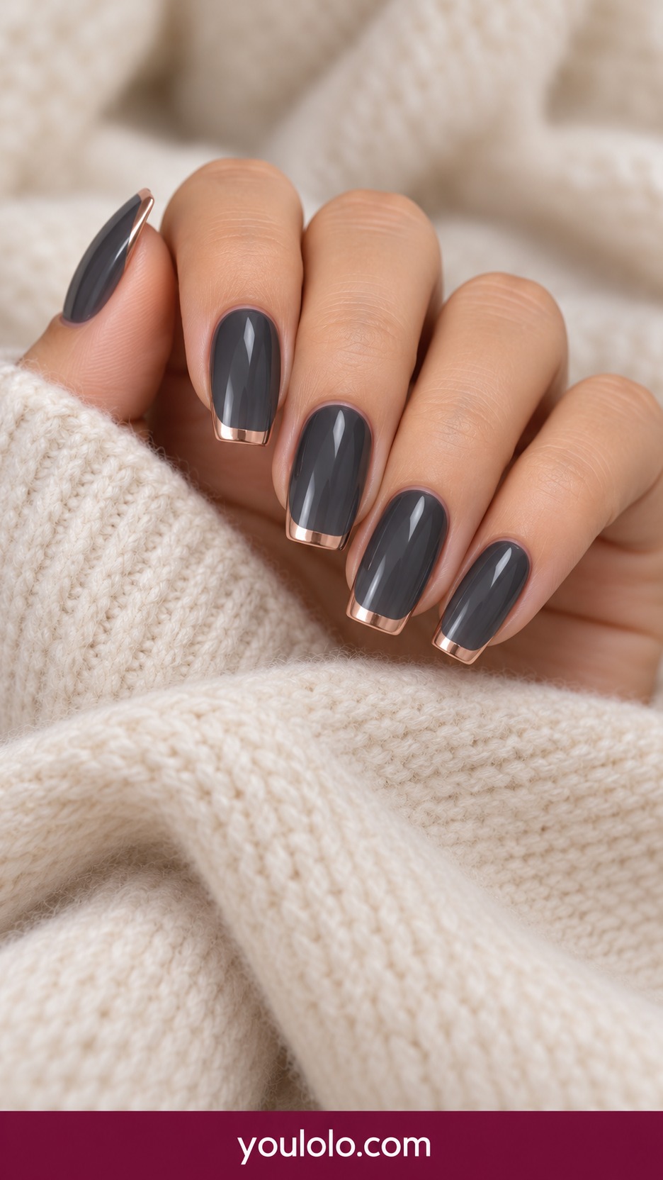Medium soft square charcoal gray nails with thin rose gold French tips on a naturally curled young adult hand