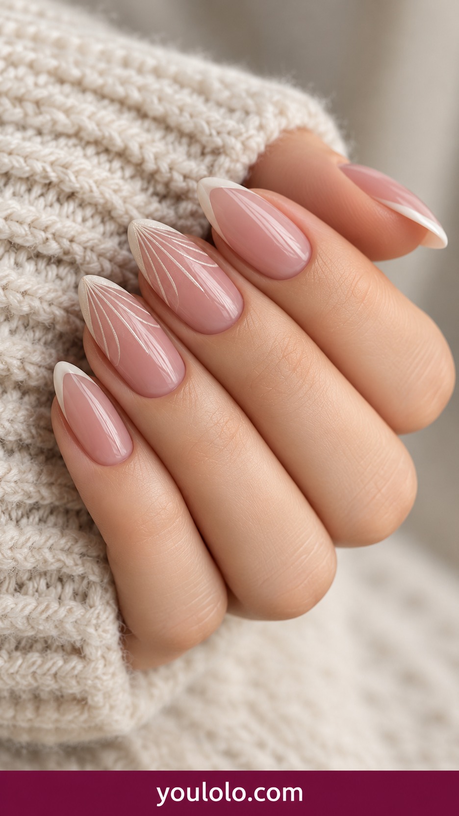 Medium almond translucent blush nails with fine ivory fan shaped radiating lines at tips on two accents, plain narrow French elsewhere on a naturally curled young adult hand