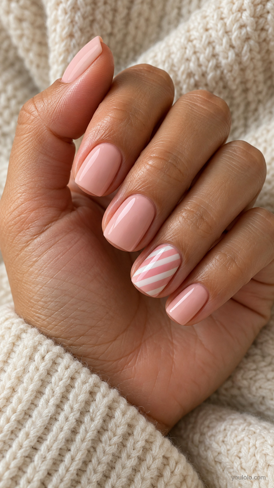 Blush square nails with diagonal pink and white stripes on one nail