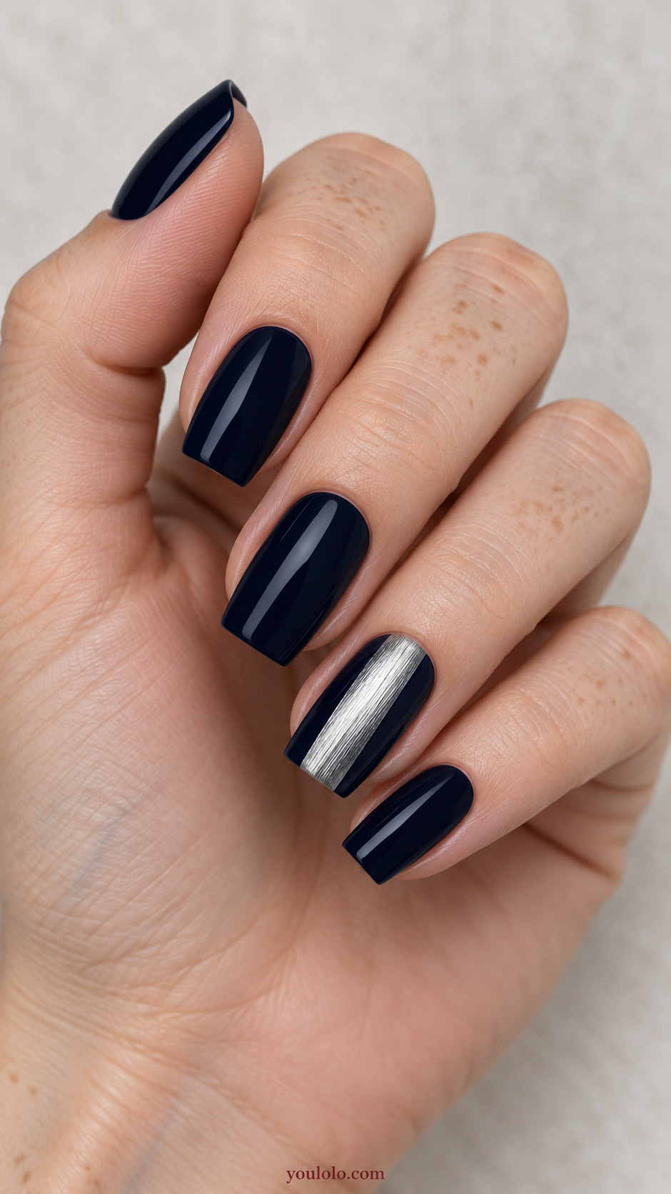 Brushed Silver Accent Panel on a naturally posed hand, showing dark blue polish and detailed nail art