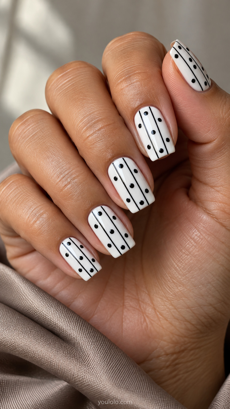 Medium square white nails with three parallel fine black vertical lines, black dots between lines in alternating staggered positions, no cross lines