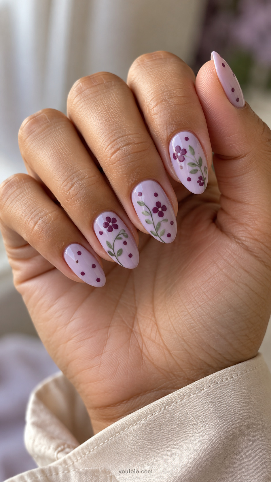 Lilac almond nails with plum flowers, fine sage stems, and plum dots.